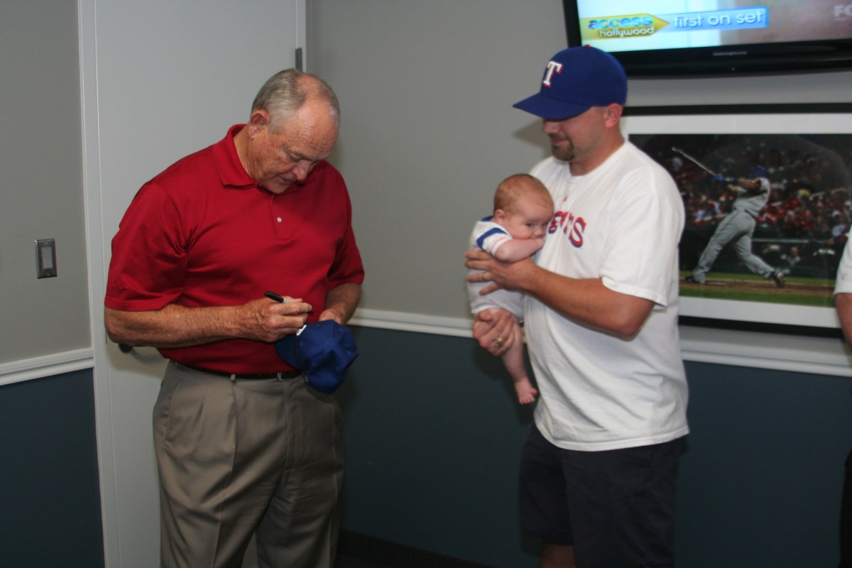Autographing Jack's cap