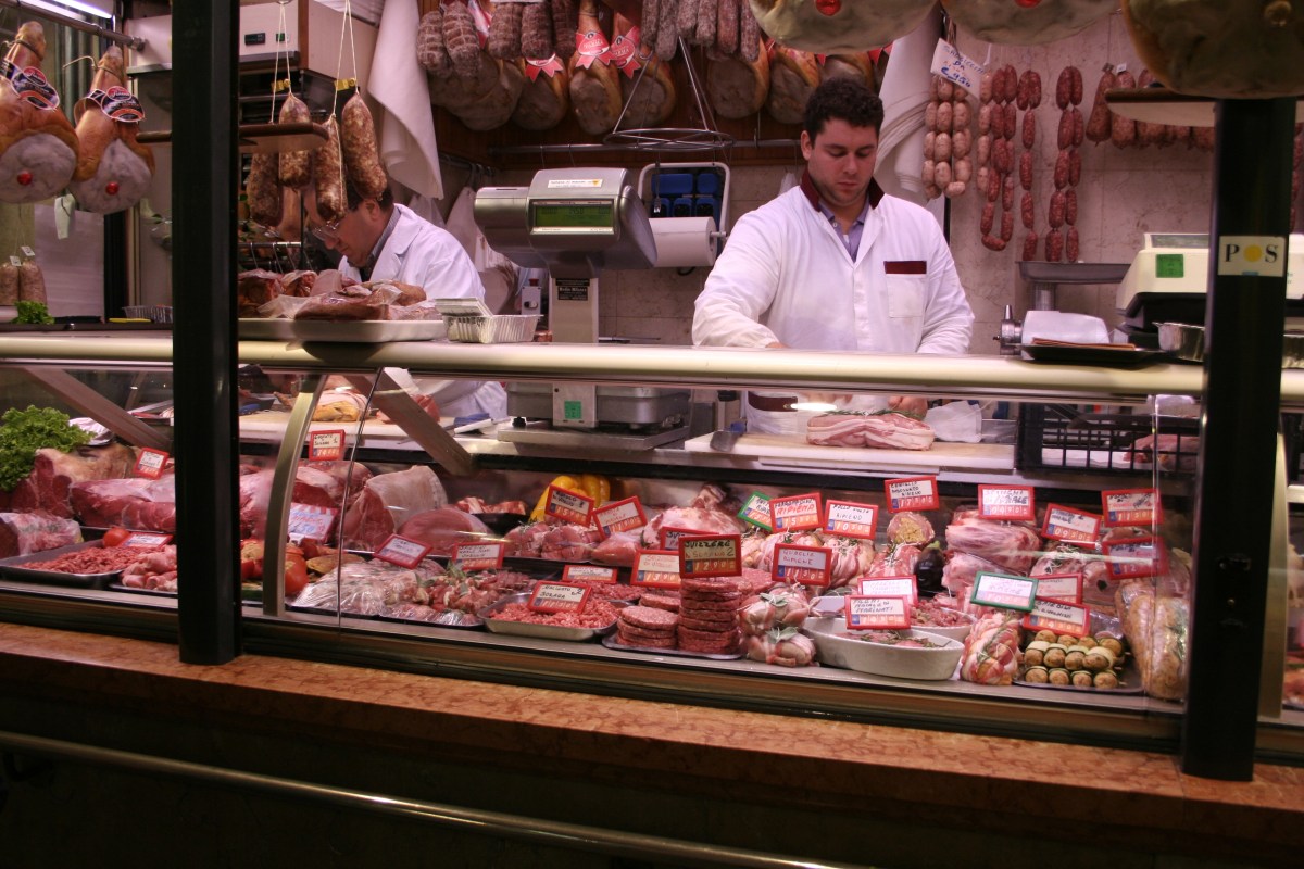 Butchers preparing counter
