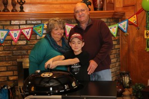 Mama J, Papa J, and Jackson with his Weber Performer