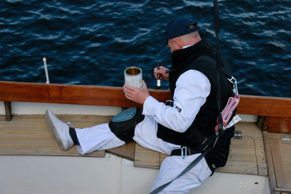 Retired yachtsman recoating boat trim